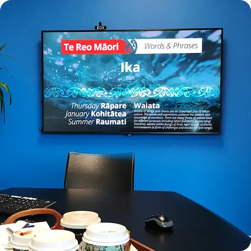 Microsoft Teams Room screen displaying company news and updates