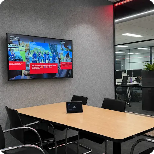 Microsoft Teams Room screen displaying branded workplace content
