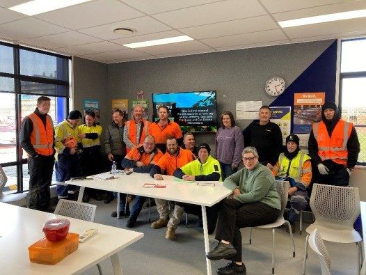 a photo of the Dimond Roofing Dunedin team showing off their Vibe.fyi screen