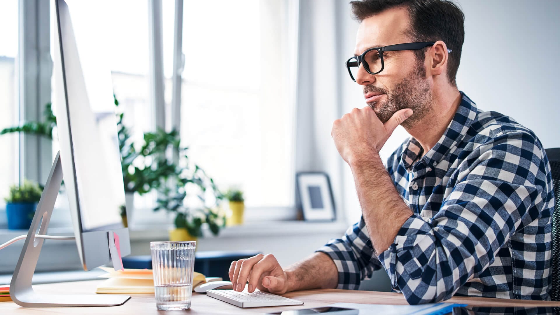 person sitting at his computer working from home