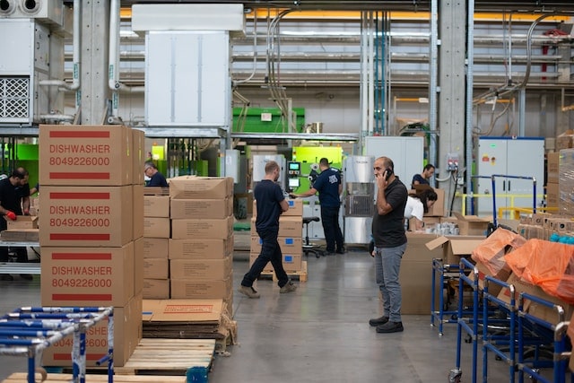 people standing in a warehouse