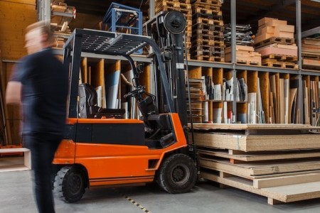 person in a warehouse with a forklift