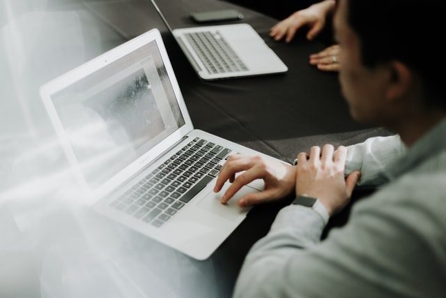 man using laptop at a meeting