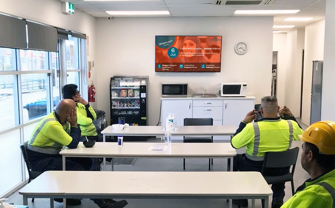 Digital signage screen displaying engaging content in a workplace setting