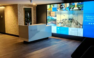 Hotel lobby screens showing local weather