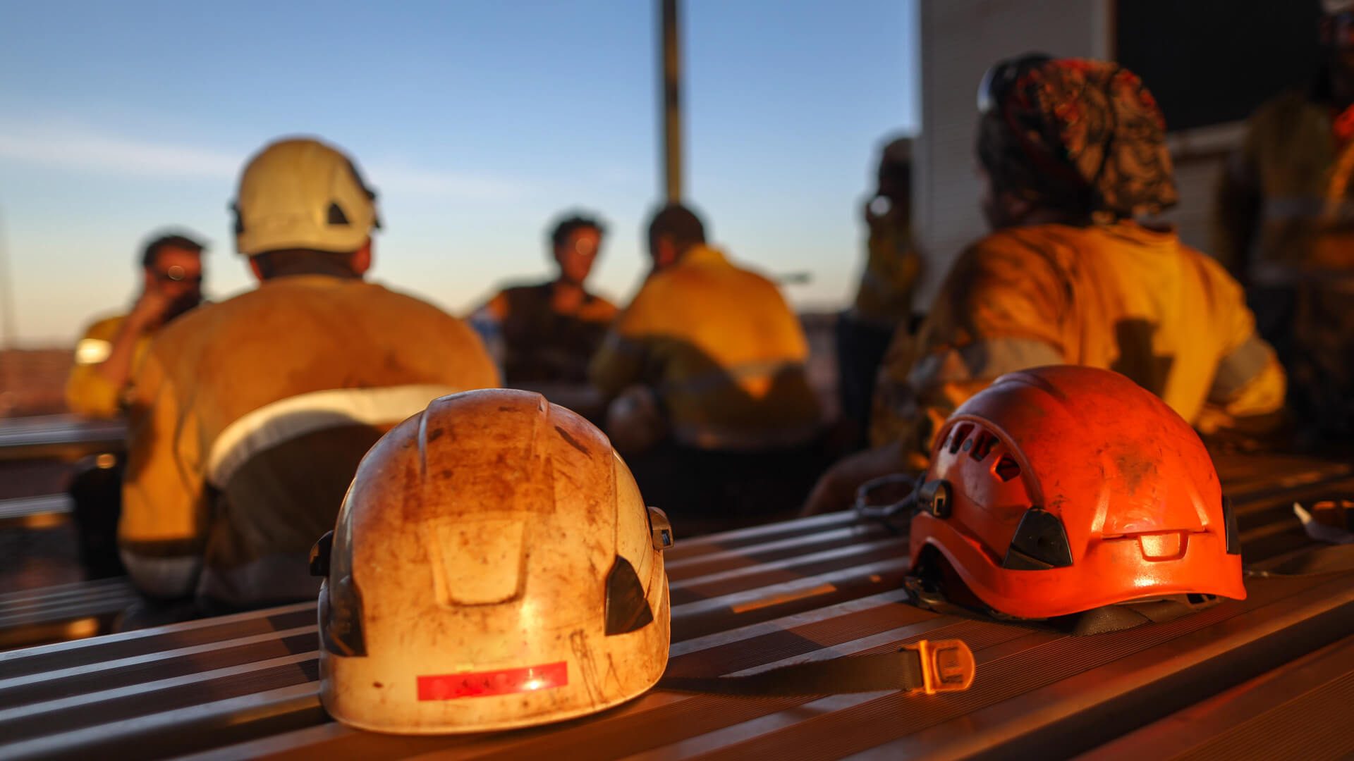 miners taking a break with their hard hats off 