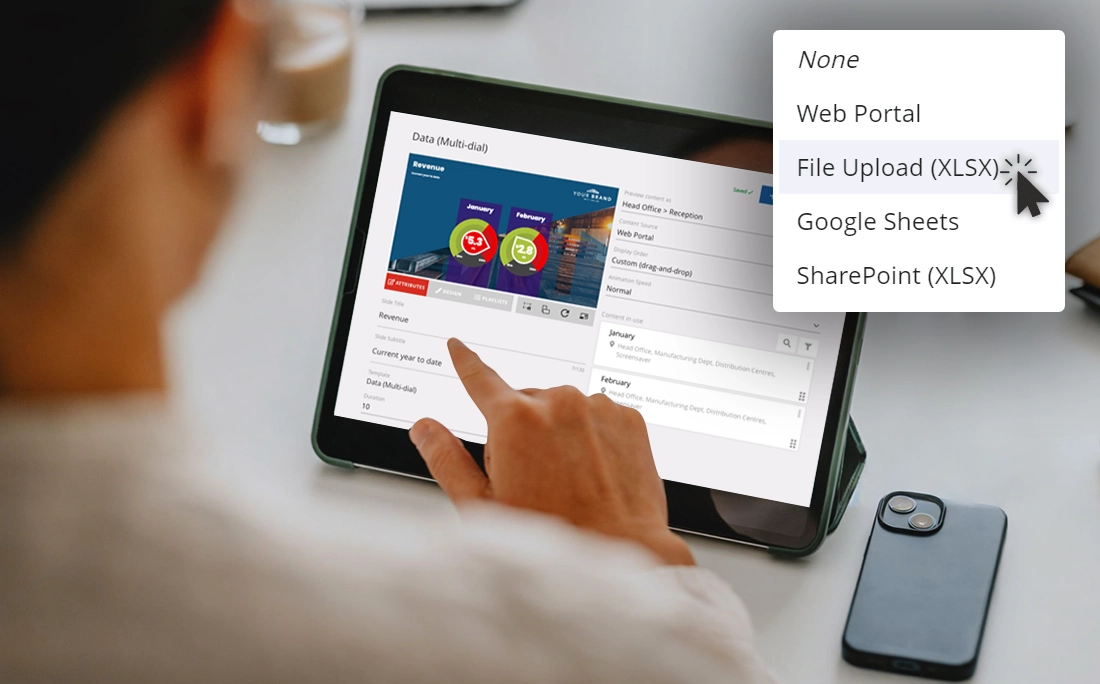 Person editing digital signage content on a mobile device